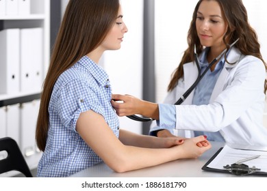 Doctor with a stethoscope in the hand examining her female patient. Health care, cardiology and medicine concepts - Shutterstock ID 1886181790