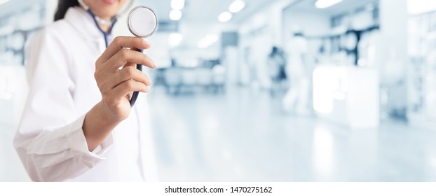 Doctor With Stethoscope In Hand And Patients Come To The Hospital Background. Medical Healthcare Staff And Doctor Service.