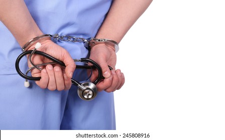Doctor with stethoscope in handcuffs isolated on white