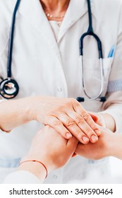 Doctor With Stethoscope Is Holding Hands Of A Female Patient