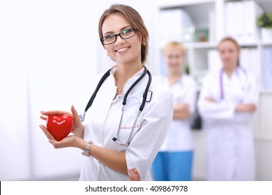 Doctor with stethoscope holding heart, isolated on white  background - Powered by Shutterstock