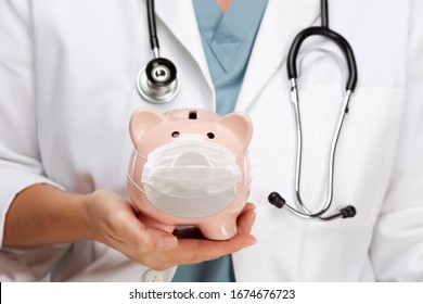 Doctor with Stethoscope Holding Piggy Bank Wearing Medical Face Mask.