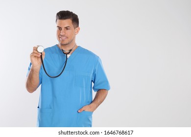 Doctor with stethoscope on light grey background. Space for text - Shutterstock ID 1646768617
