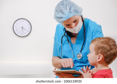 Doctor With Stethoscope And Tablet On White Background. Nurse Talking With The Child Patient