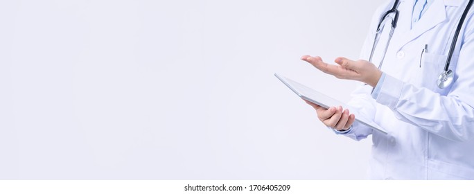 Doctor with stethoscope in white coat holding tablet, showing medical information, diagnosis, isolated on white background, close up, cropped view. - Powered by Shutterstock