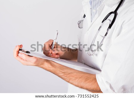 Doctor with a stethoscope writing a prescription