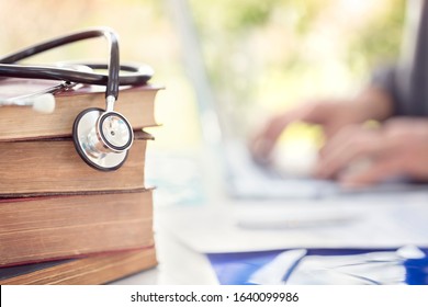 Doctor Or Student At Medical College With Stack Of Books And Stethoscope