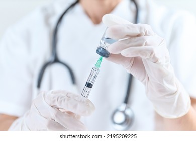 Doctor Sucking An Injection Drug From A Vial Bottle
