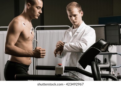 Doctor is supervising the athlete on a treadmill - Powered by Shutterstock