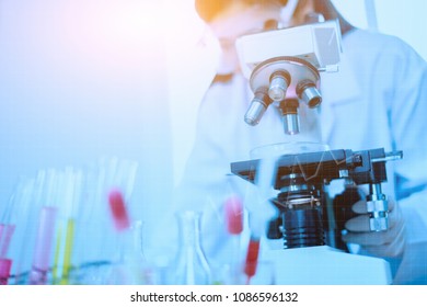 Doctor Supervisor Looking At The Microscope Slide In The Forensic,Laboratory Medical Scientists Working At Lab With Test Tubes Researcher Performs Liquid,Laboratory Concept With Medical Icon