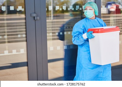 Doctor or surgeon with organ transport after organ donation for surgery in front of the clinic in protective clothing