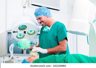 Doctor Surgeon With Patient In Operating Room Applying Anesthetic With Mask