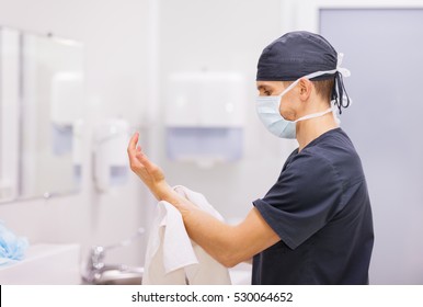 Doctor surgeon preparing for surgery and washes his hands - Powered by Shutterstock