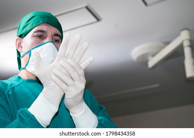 Doctor surgeon and surgical assistant doctor or scrubbing wear surgical gowns and surgical gloves to prepare for surgery before starting the operation, Step by step procedures. Surgery team.