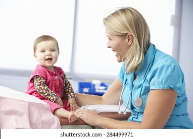 Doctor In Surgery Examining Baby Girl