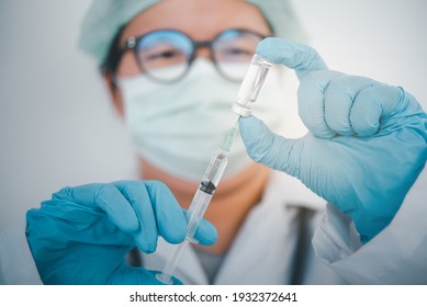 Doctor with syringe ready for injection of vaccine to patient. Vaccination concept.	 - Shutterstock ID 1932372641