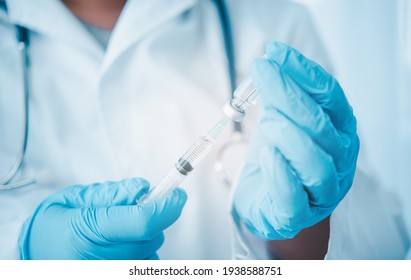 Doctor with syringe ready for injection of vaccine to patient. Vaccination concept.	 - Shutterstock ID 1938588751