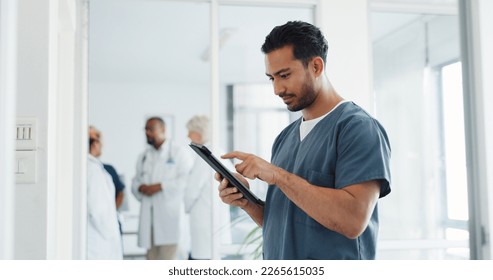 Doctor, tablet and research or planning schedule for healthcare, online medical consultation or search website. Asian man, nurse and reading report or patient analysis on tech device in hospital - Powered by Shutterstock