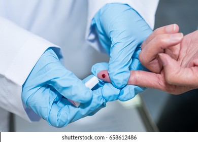 Doctor take Blood Sample from Patient's Fingertip. Closed-up.