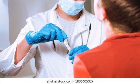 Doctor Takes A Cotton Swab Coronavirus Test From Child Nose To Analyse If Postitve For Covid-19.