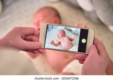 The Doctor Takes A Video On The Phone With A Newborn Baby. A Nurse Holds An Online Conference On The Treatment Of A Child