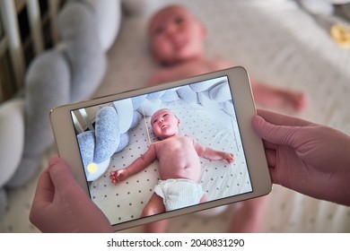 The Doctor Takes A Video On A Tablet With A Newborn Baby. A Nurse Conducts An Online Consultation On The Treatment Of A Child