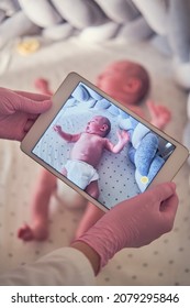 The Doctor Takes A Video On A Tablet With A Newborn Baby. A Nurse Conducts An Online Consultation On The Treatment Of A Child