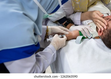 Doctor Taking Blood To Examine The Sickness For Child.