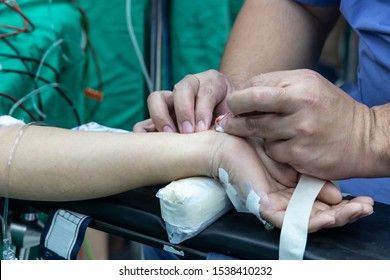 Doctor Taking Blood Sample From Patient In The Operating Room. Blood Drawing Sample For Blood Test The Health.