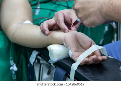 Doctor Taking Blood Sample From Patient In The Operating Room. Blood Drawing Sample For Blood Test The Health.