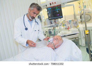 Doctor Taking Care Of Critically Ill Patient