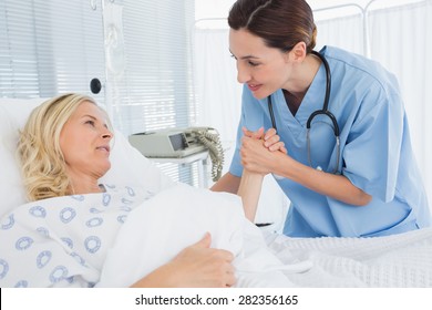 Doctor Taking Care Of Patient In Hospital Room