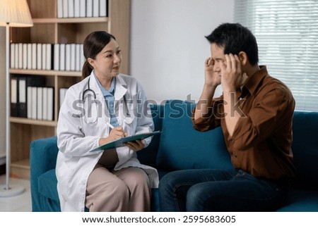 Doctor taking notes while listening to patient describing headache symptoms during medical examination in hospital office