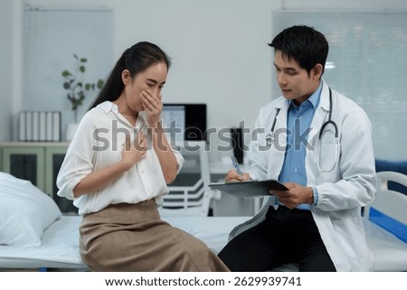 Doctor taking notes while visiting sick patient coughing in hospital room