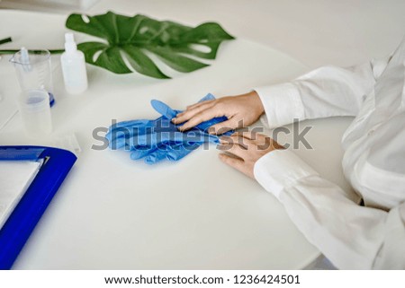 doctor taking off sterile gloves