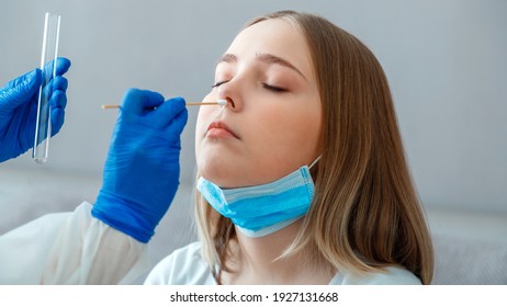 Doctor taking PCR test nasopharyngeal culture to woman patient. Nurse take saliva sample through nose with cotton swab check coronavirus covid 19 test. Diagnostics testing patients. Long web banner - Shutterstock ID 1927131668