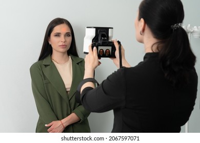 Doctor Taking Picture Of Female Patient Before Aesthetic Treatment On White Background With 3d Camera System