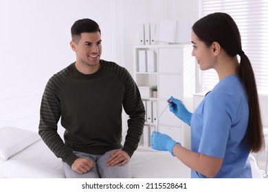 Doctor Taking Sample For STD Testing From Man In Clinic