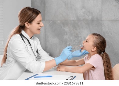 Doctor taking throat swab sample from girl`s oral cavity indoors - Powered by Shutterstock