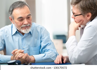 Doctor Talking To Her Male Patient At Office