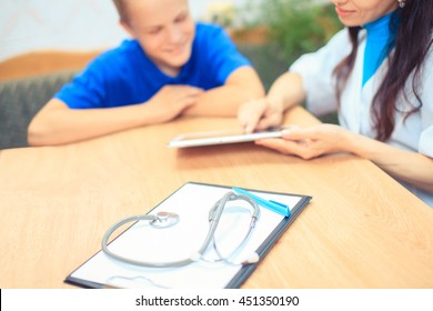 Doctor Talking To Her Male Patient At Office