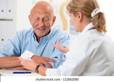 Doctor Talking To Her Male Senior Patient At Office