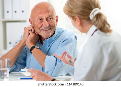 doctor talking to her male senior patient at office - Powered by Shutterstock