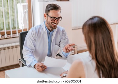 Doctor talking and laughing with his patient
