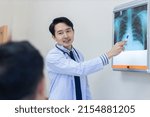 Doctor talking on problem point on x-ray film. x-ray film show skeleton on film. Surgery medical technology concept. Osteoarthritis in the elderly.