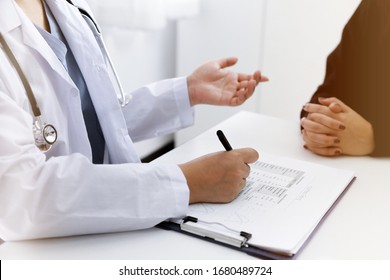 Doctor talking with  patient in doctors office.