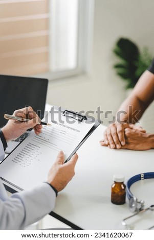 Doctor talking to patient and filling patient history, examination, treatment, medical and health concept.	