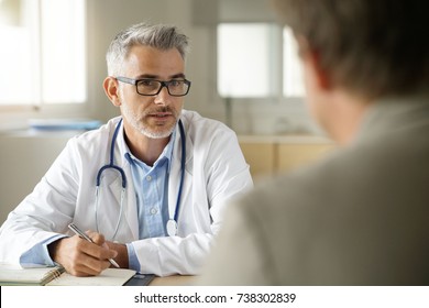 Doctor Talking To Patient In Office