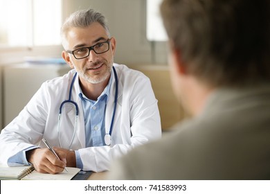 Doctor Talking To Patient In Office