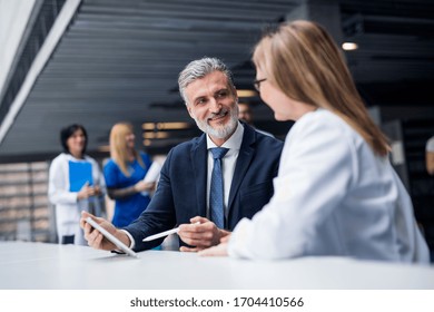 Doctor talking to a pharmaceutical sales representative.